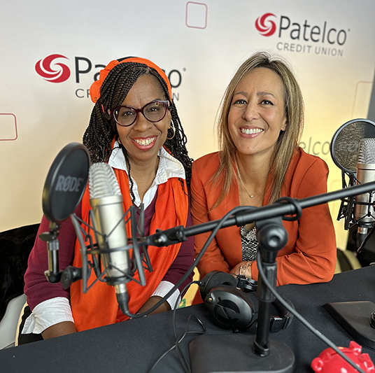 Patelco employees Michele Enriquez and Veronica Dangerfield at the podcast desk.